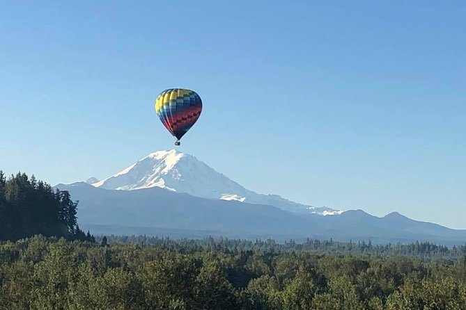 Sky bound Adventures Snohomish Sunrise Hot Air Balloon Ride - Soaring low over treetops, then higher toward mountains and water